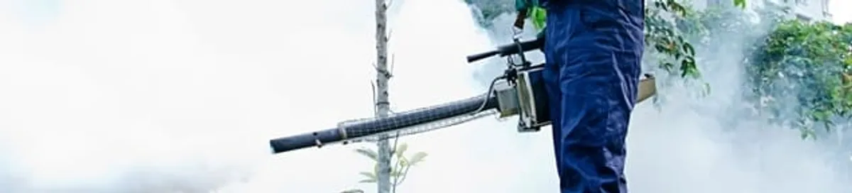 Pest control technician fogging an outdoor area for insect control in Portland, OR