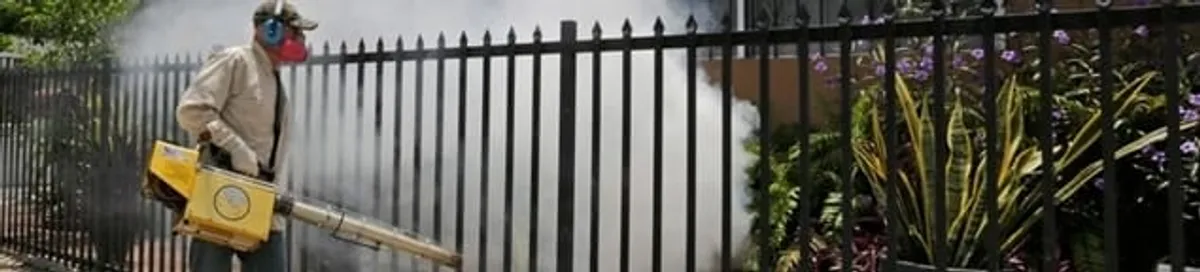 Mosquito control technician fogging a yard perimeter for mosquito reduction in Portland, OR